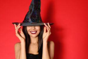 Woman wearing a witch hat and red lipstick